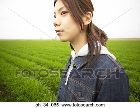 Stock Photography - Young women standing in a field. Fotosearch