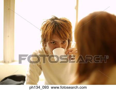 Stock Image - Young couple having tea. Fotosearch
