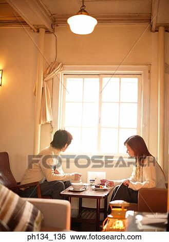 Stock Photograph - Young couple sitting together. Fotosearch