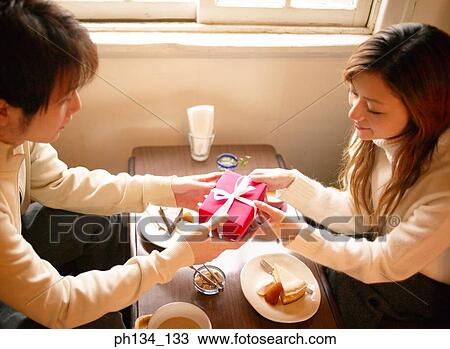 Young couple with gift View Large Photo Image Stock Image - Young couple with gift. Fotosearch