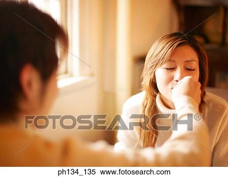 Young man feeding a young woman View Large Photo Image Stock Photography - Young man feeding a young woman. Fotosearch
