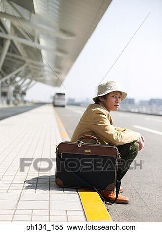 Young man sitting and waiting View Large Photo Image Stock Photography - Young man sitting and waiting. Fotosearch