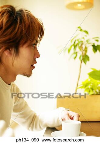 Young man with coffee cup View Large Photo Image Stock Image - Young man with coffee cup. Fotosearch