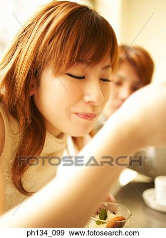 Young woman eating View Large Photo Image Stock Photo - Young woman eating. Fotosearch