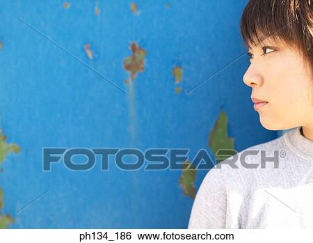 Young woman looking around View Large Photo Image Stock Photograph - Young woman looking around. Fotosearch