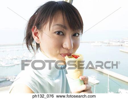 Young woman eating a sandwich on a deck View Large Photo Image Stock Photograph - Young woman eating a sandwich on a deck. Fotosearch