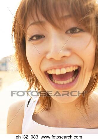 Stock Image - Young woman laughing. Fotosearch
