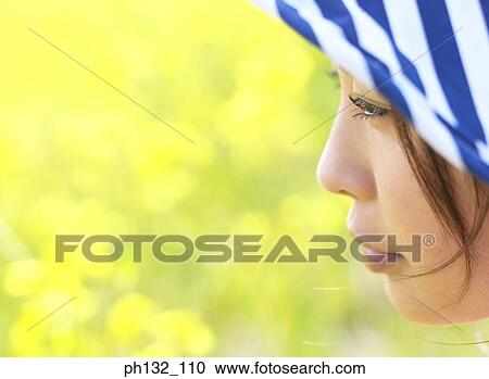 Young woman looking downwards View Large Photo Image Stock Image - Young woman looking downwards. Fotosearch