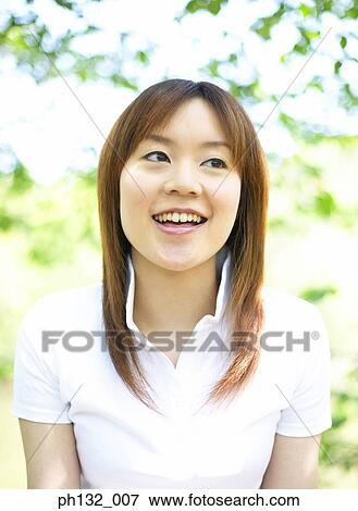 Young woman smiling View Large Photo Image Stock Photo - Young woman smiling. Fotosearch