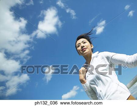 Young woman standing on boat View Large Photo Image Stock Photograph - Young woman standing on boat. Fotosearch