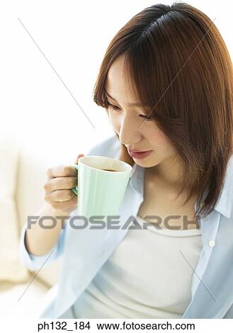 Picture - Young woman drinking tea. Fotosearch