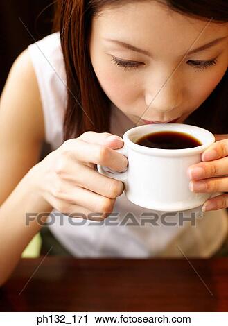 Young woman drinking tea View Large Photo Image Stock Image - Young woman drinking tea. Fotosearch