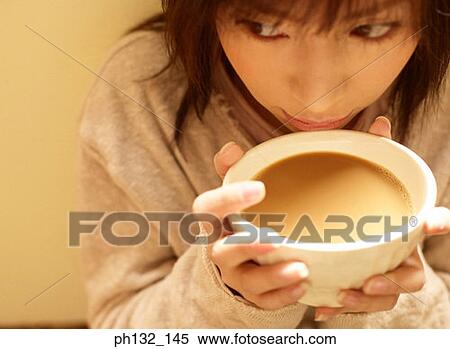 Young woman drinking tea View Large Photo Image Stock Photography - Young woman drinking tea. Fotosearch