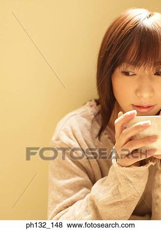 Young woman holding a bowl View Large Photo Image Stock Photo - Young woman holding a bowl. Fotosearch