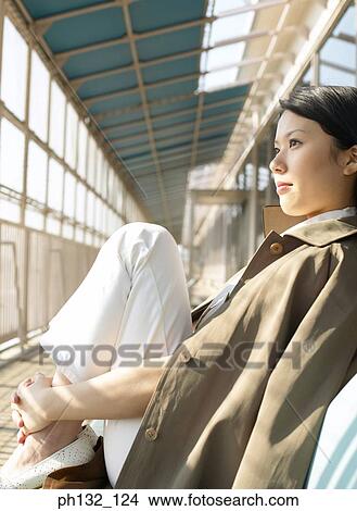 Young woman sitting indoors View Large Photo Image Picture - Young woman sitting indoors. Fotosearch