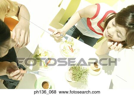 Stock Photo - High angle view of a young couple at a table. Fotosearch