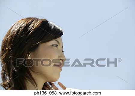 Side profile of a young woman looking ahead View Large Photo Image Stock Photo - Side profile of a young woman looking ahead. Fotosearch