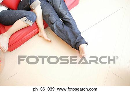 View of legs of a young couple on a couch View Large Photo Image Stock Photo - View of legs of a young couple on a couch. Fotosearch