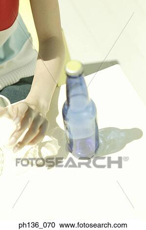 Stock Image - Woman's hand holding an empty wine glass. Fotosearch