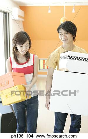 Picture - Young couple carrying boxes. Fotosearch