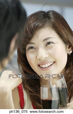 Stock Photography - Young couple drinking red wine. Fotosearch