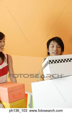 Young couple holding boxes View Large Photo Image Stock Image - Young couple holding boxes. Fotosearch