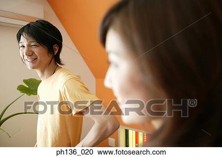 Young couple looking ahead smiling View Large Photo Image Stock Image - Young couple looking ahead smiling. Fotosearch