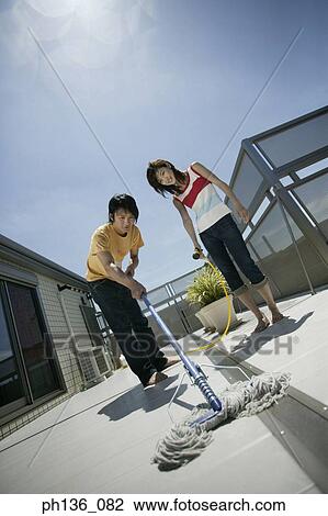 Stock Image - Young couple washing the floor. Fotosearch