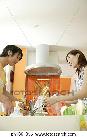 Young couple working together in the kitchen View Large Photo Image Stock Photography - Young couple working together in the kitchen. Fotosearch