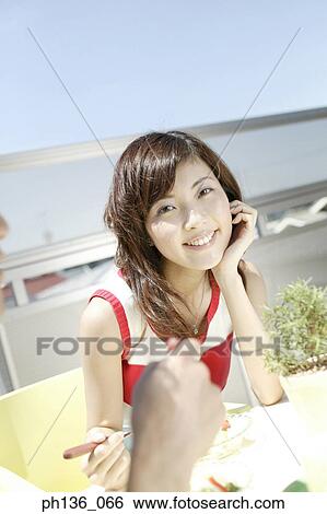Young woman looking at camera View Large Photo Image Stock Photograph - Young woman looking at camera. Fotosearch