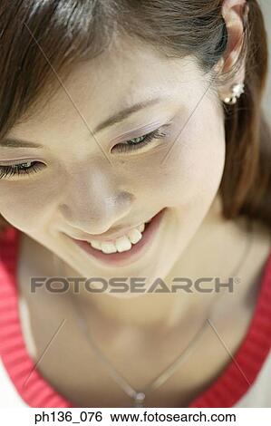 Stock Photograph - Young woman looking down. Fotosearch
