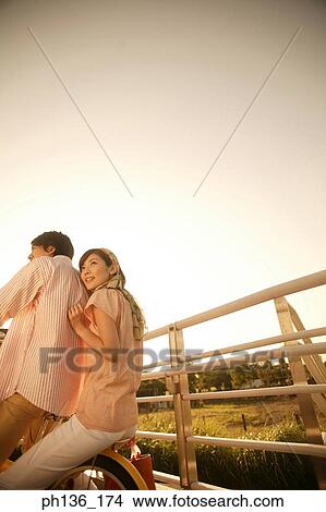 Young couple Riding a bicycle View Large Photo Image Picture - Young couple Riding a bicycle. Fotosearch