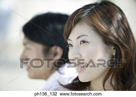 Young couple sitting back to back View Large Photo Image Stock Image - Young couple sitting back to back. Fotosearch