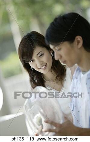 Stock Photo - Young couple standing together. Fotosearch