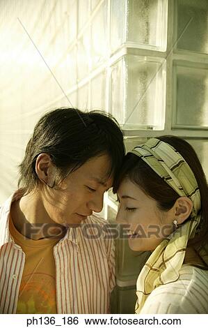 Young couple with their fore heads touching View Large Photo Image Stock Photograph - Young couple with their fore heads touching. Fotosearch