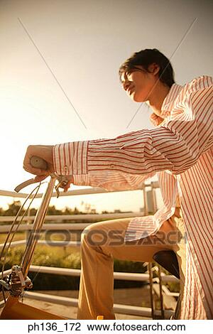 Stock Image - Young man Riding a bicycle. Fotosearch