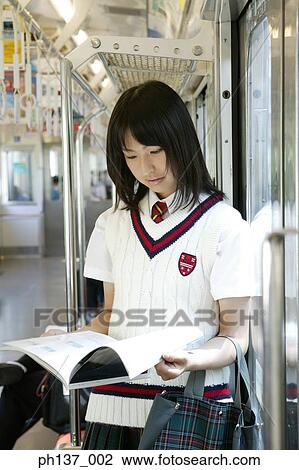 Teenage girl Reading a Book in the train View Large Photo Image Stock Image - Teenage girl Reading a Book in the train. Fotosearch