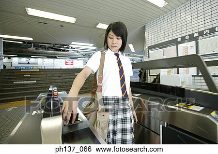 Stock Photograph - Teenage girl taking a ticket. Fotosearch