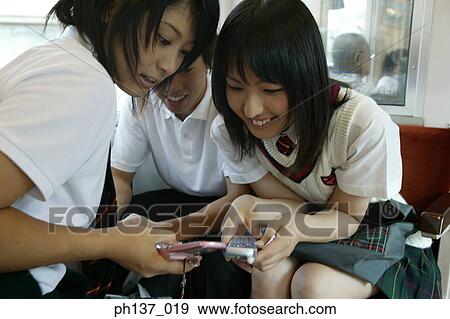 Teenagers sitting in a train talking View Large Photo Image Stock Photo - Teenagers sitting in a train talking. Fotosearch
