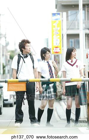 Teenagers standing and waiting at a railway crossing View Large Photo Image Stock Image - Teenagers standing and waiting at a railway crossing. Fotosearch