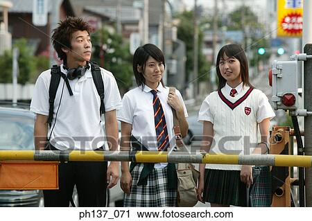Teenagers standing and waiting at a railway crossing View Large Photo Image Stock Image - Teenagers standing and waiting at a railway crossing. Fotosearch