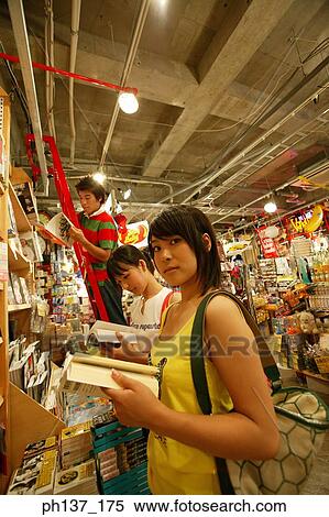 Teenagers looking at books in a store View Large Photo Image Stock Photography - Teenagers looking at books in a store. Fotosearch