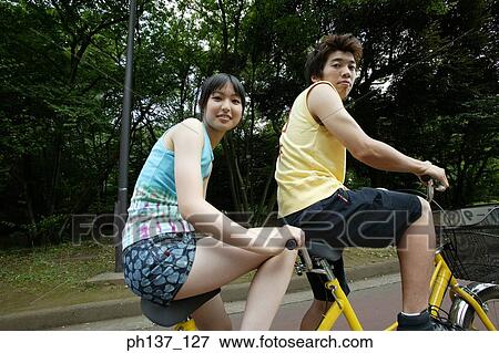 Teenagers riding a tandem bicycle View Large Photo Image Stock Photo - Teenagers riding a tandem bicycle. Fotosearch