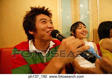 Teenagers singing at a karaoke bar View Large Photo Image Stock Image - Teenagers singing at a karaoke bar. Fotosearch