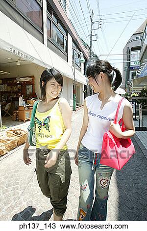 Teenagers walking and talking View Large Photo Image Stock Image - Teenagers walking and talking. Fotosearch