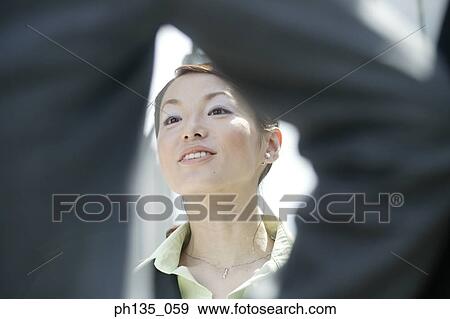 Low angle view of a young businesswoman talking to a man View Large Photo Image Stock Photo - Low angle view of a young businesswoman talking to a man. Fotosearch