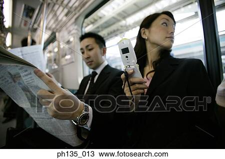 Low angle view of young business executives traveling to work View Large Photo Image Stock Image - Low angle view of young business executives traveling to work. Fotosearch