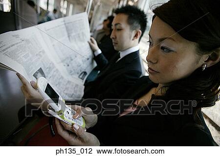 Stock Image - Side profile of young business executives traveling to work. Fotosearch