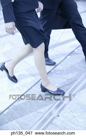 View of the legs of a man and woman climbing Steps View Large Photo Image Stock Photo - View of the legs of a man and woman climbing Steps. Fotosearch