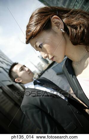 Young business executives crossing each other on a sidewalk View Large Photo Image Picture - Young business executives crossing each other on a sidewalk. Fotosearch